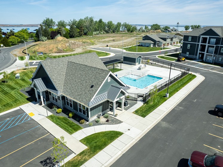 A view of a parking lot with a building and a pool.